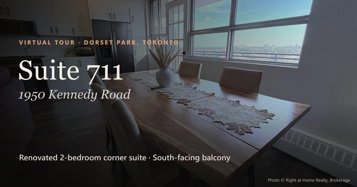 Suite 711, 1950 Kennedy Road, Dorset Park, Toronto: a dining table in front of tall windows over the city.